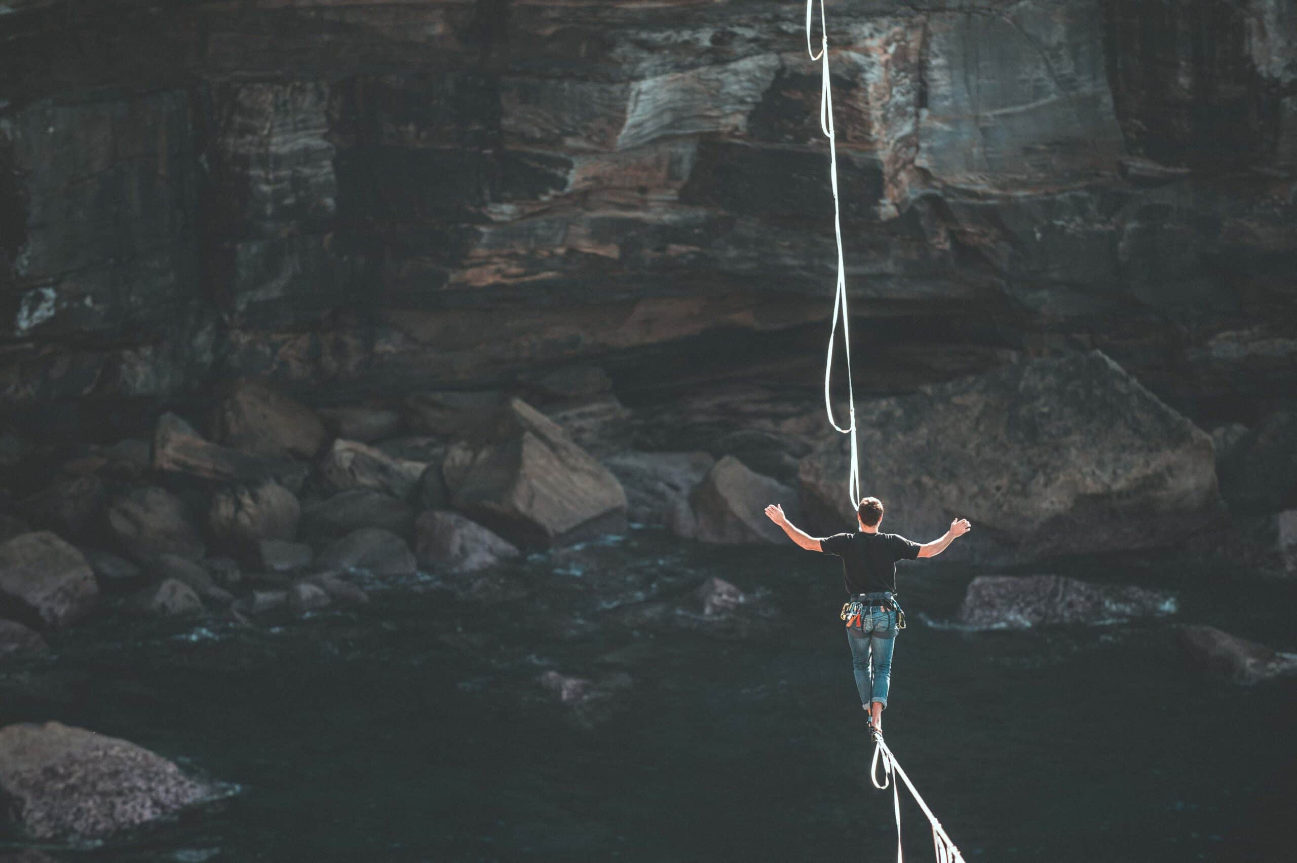 man on rope to symbolise how fragile can be our defense in cybersecurity and we are walking on a thin line unaware